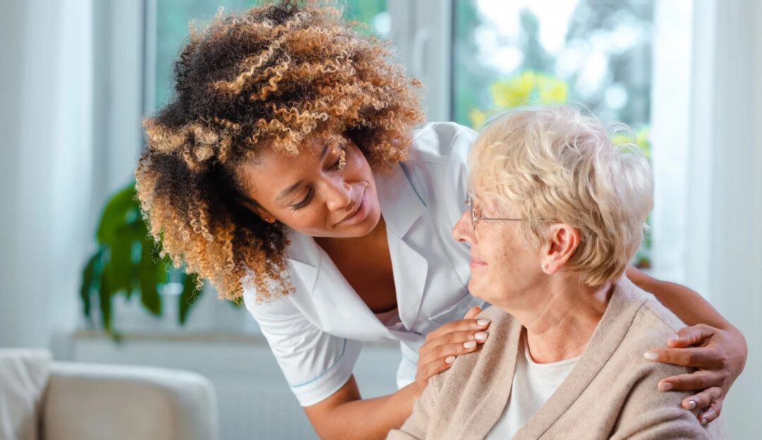 Caregiver at care homes in Devon comforting an elderly woman